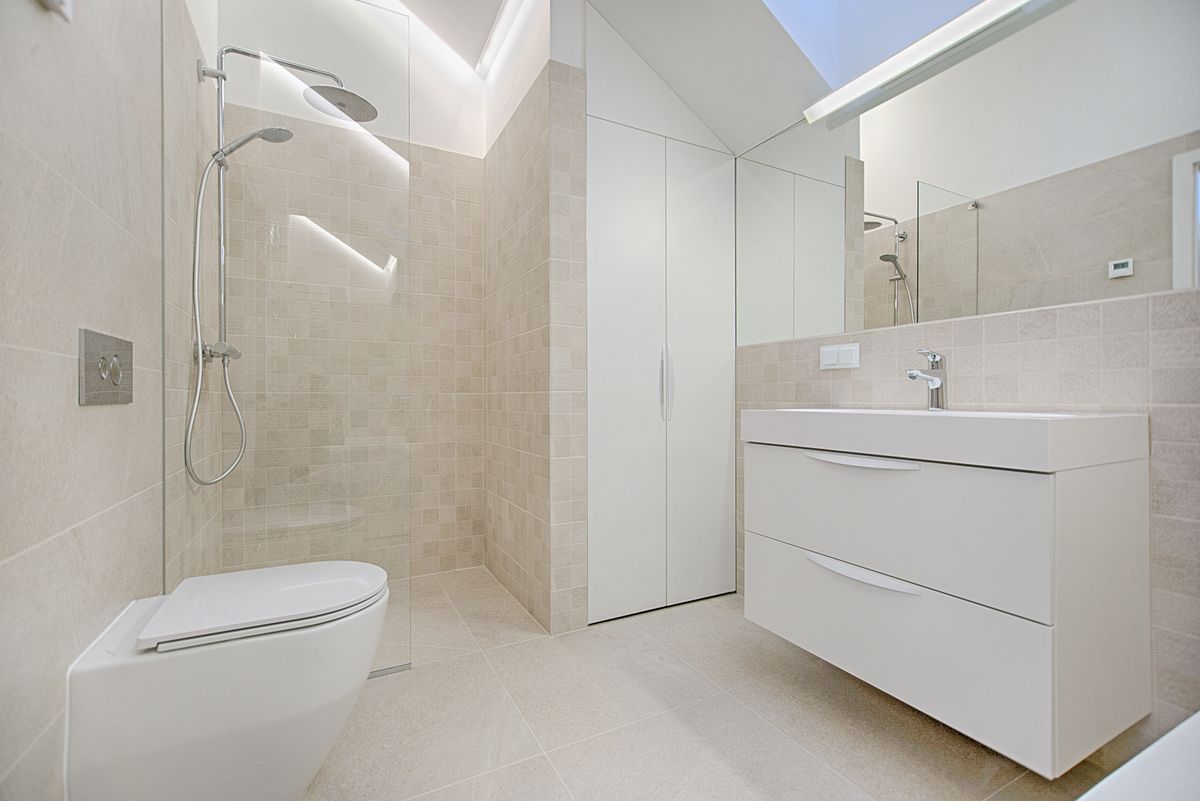 recessed shower niche providing storage in a small bathroom