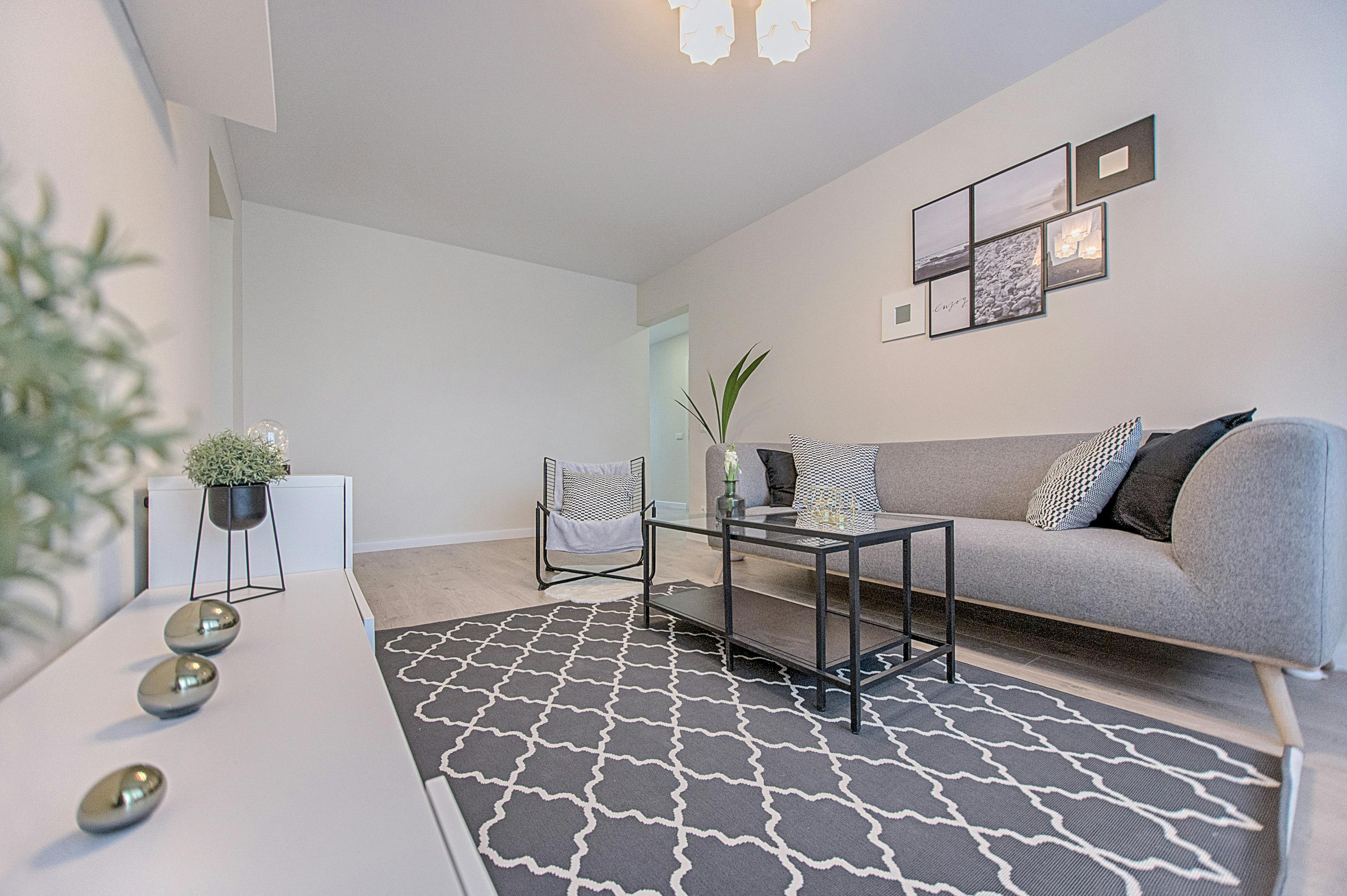 three gray ornaments on white wooden desk inside living room