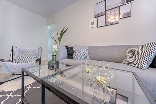 A stylish and comfortable living room featuring modern geometric decor and contemporary design elements.