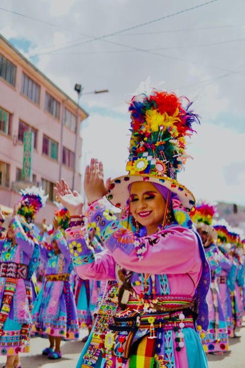 Free Vibrant parade with women in colorful, traditional attire dancing joyfully outdoors. Stock Photo