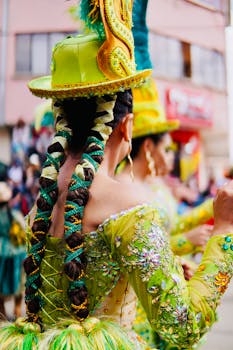 A lively festival scene with people wearing ornate green costumes, showcasing cultural dance and performance.