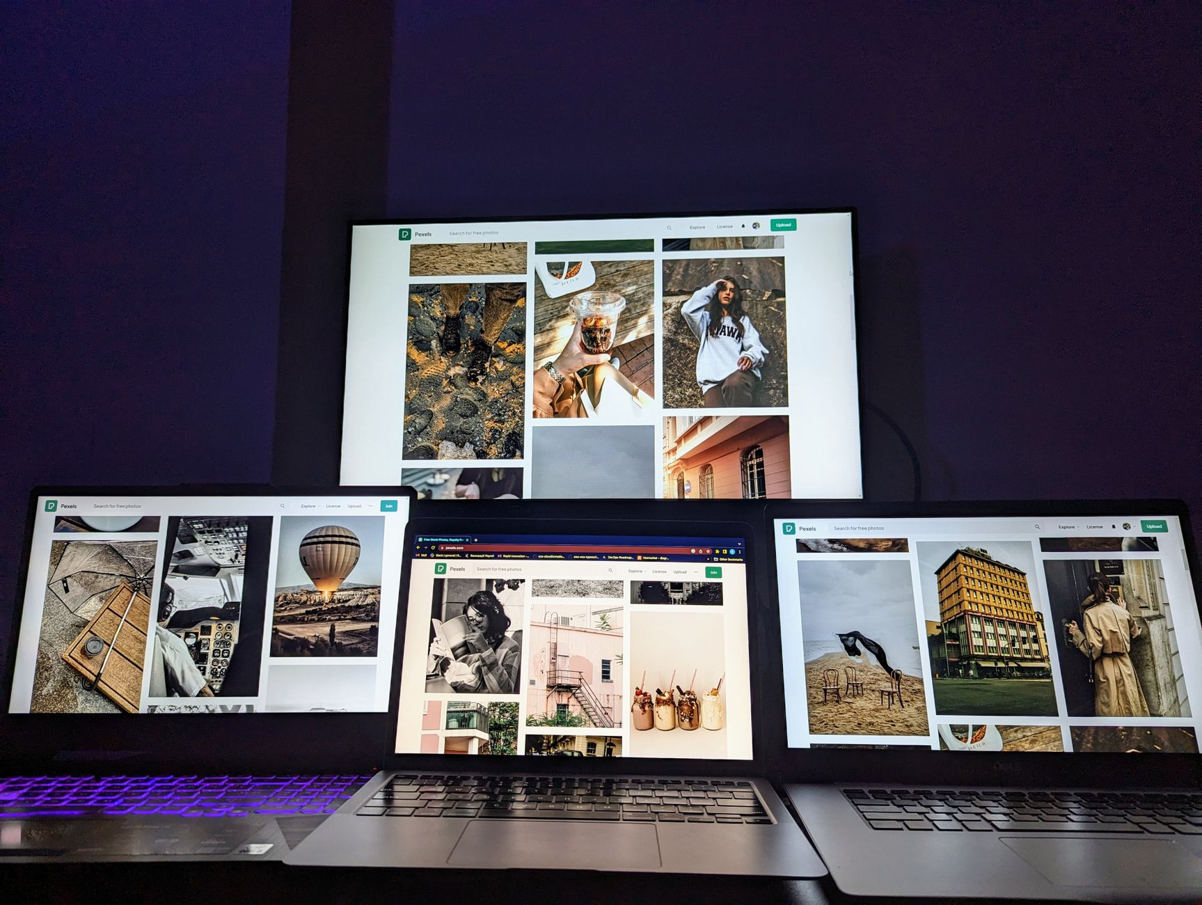 A modern digital setup with multiple screens showcasing diverse photographs, ideal for creatives.