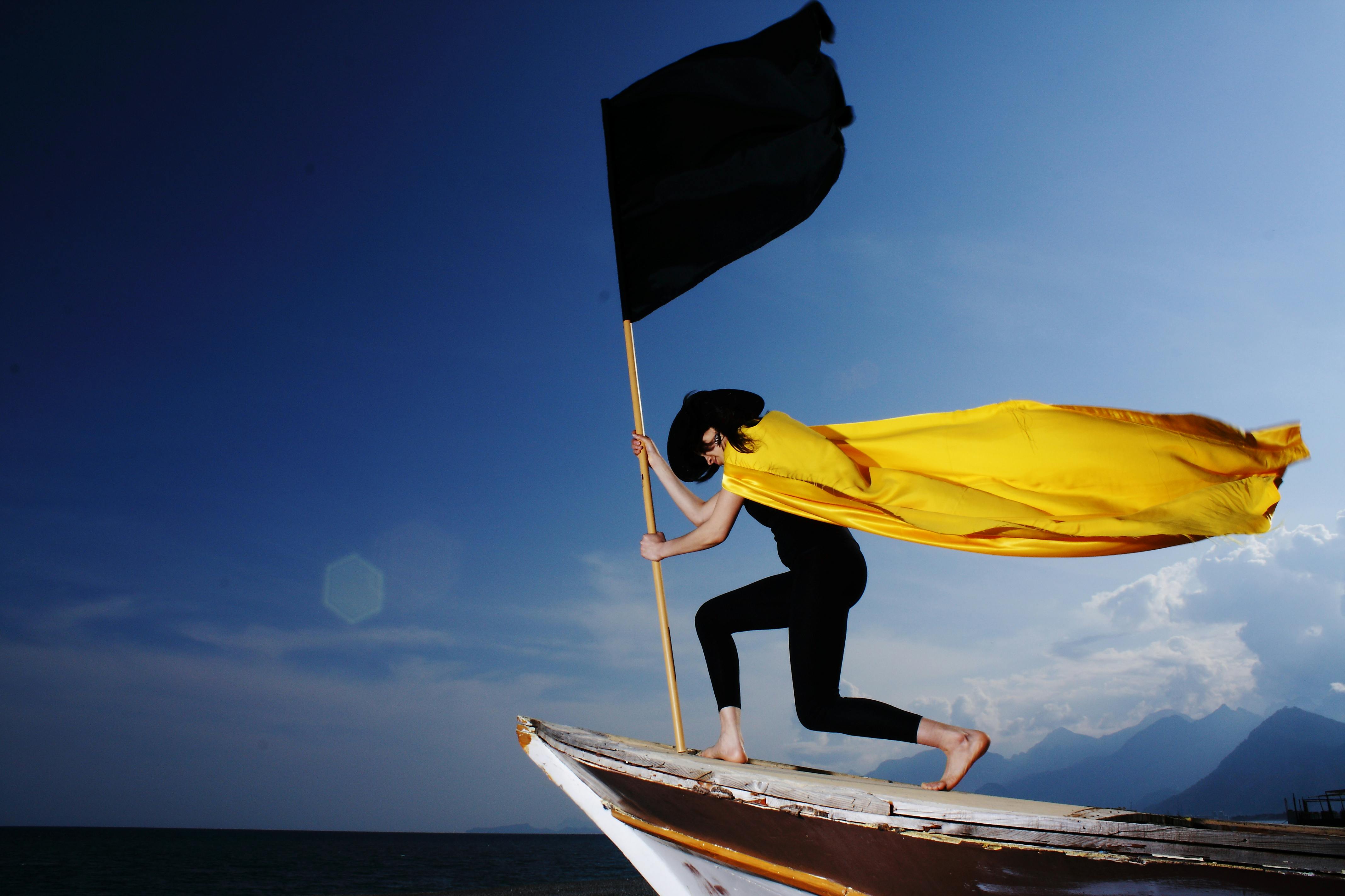 woman holding black flag