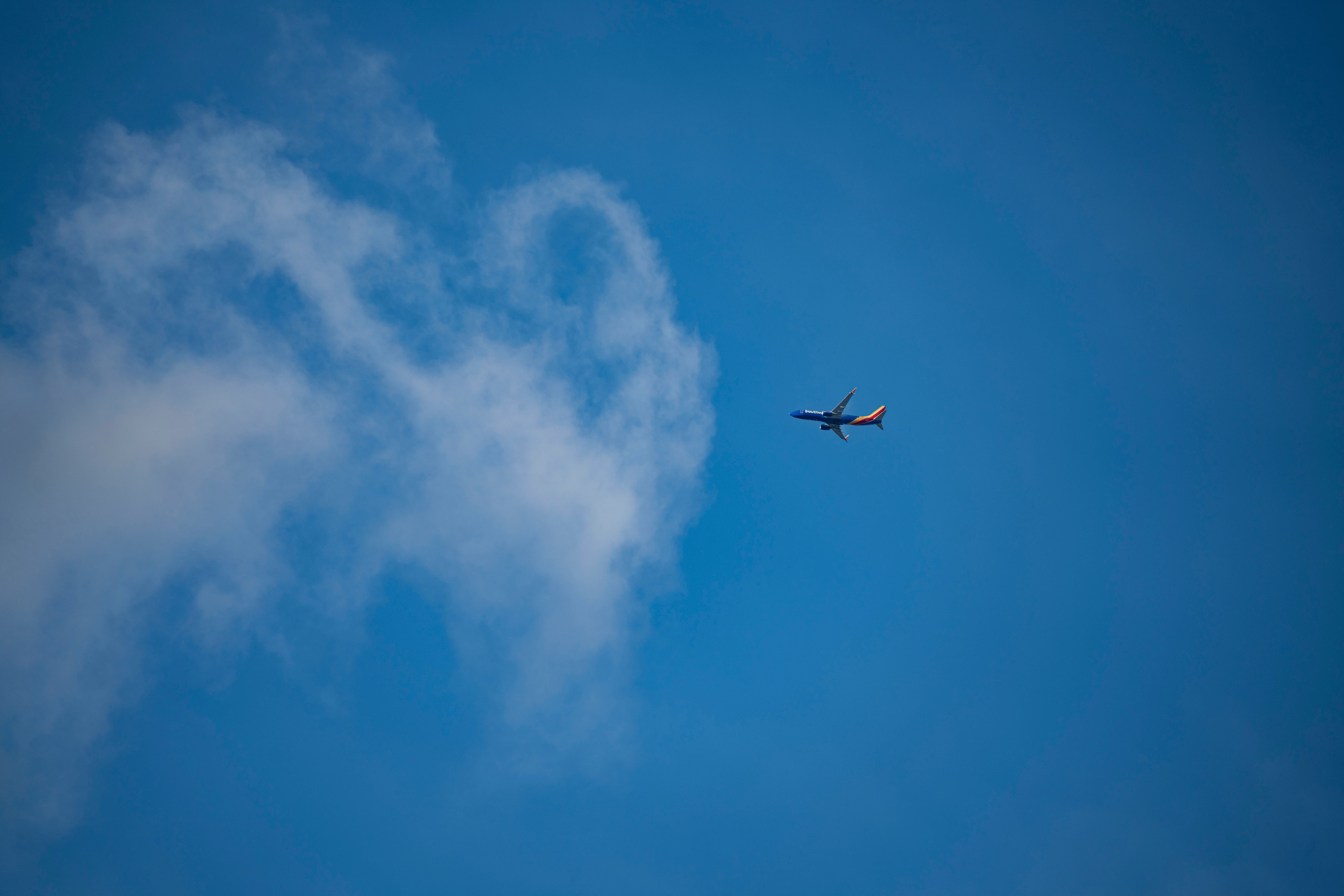Airplane Flying on the Background of a Blue Sky · Free Stock Photo