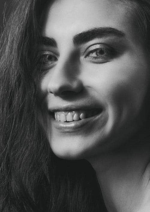 Black and White Close-up Portrait of a Smiling Woman 