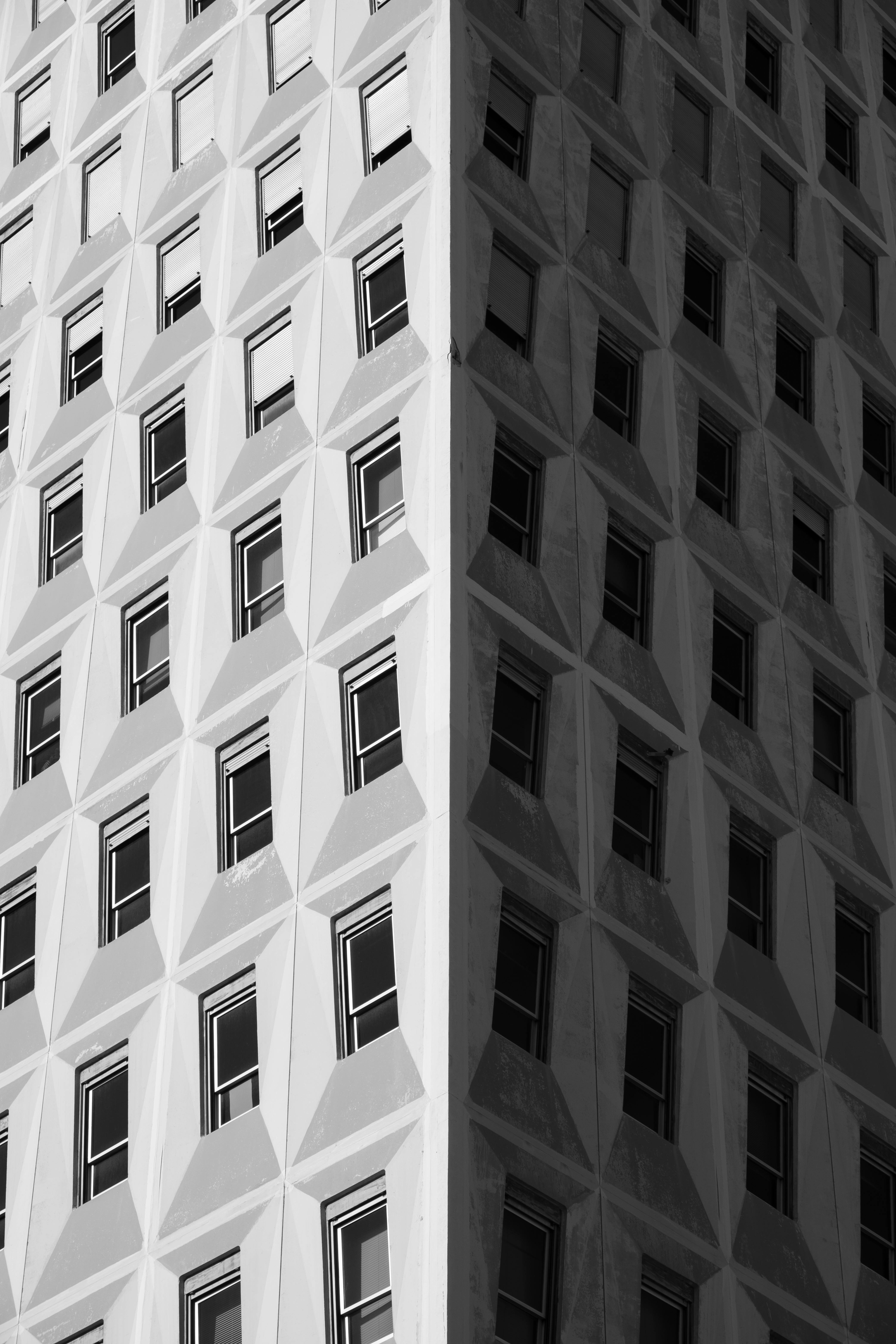 A black and white abstract view of a geometric building facade in France.