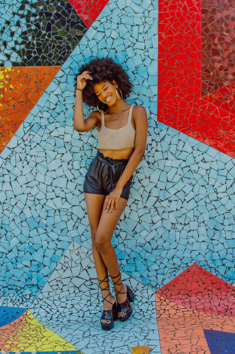 Smiling Woman Leaning On The Mosaic Wall