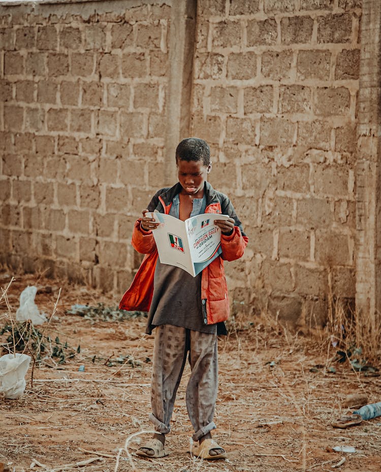 Boy Reading A Newspaper 