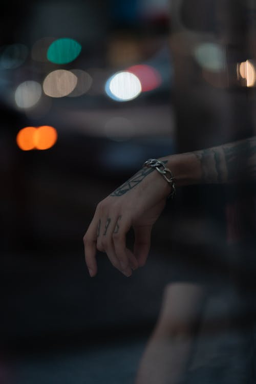 Tattoos and Bracelet on Hand