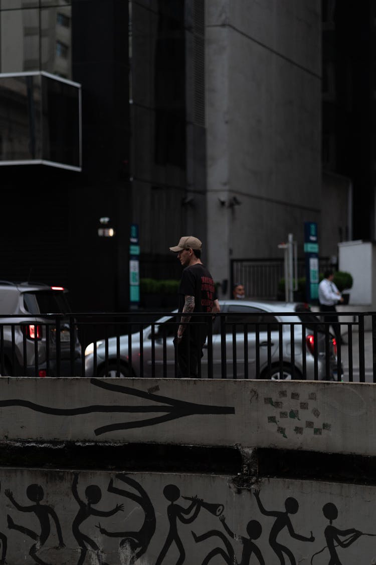 Man Walking Near Wall With Graffiti