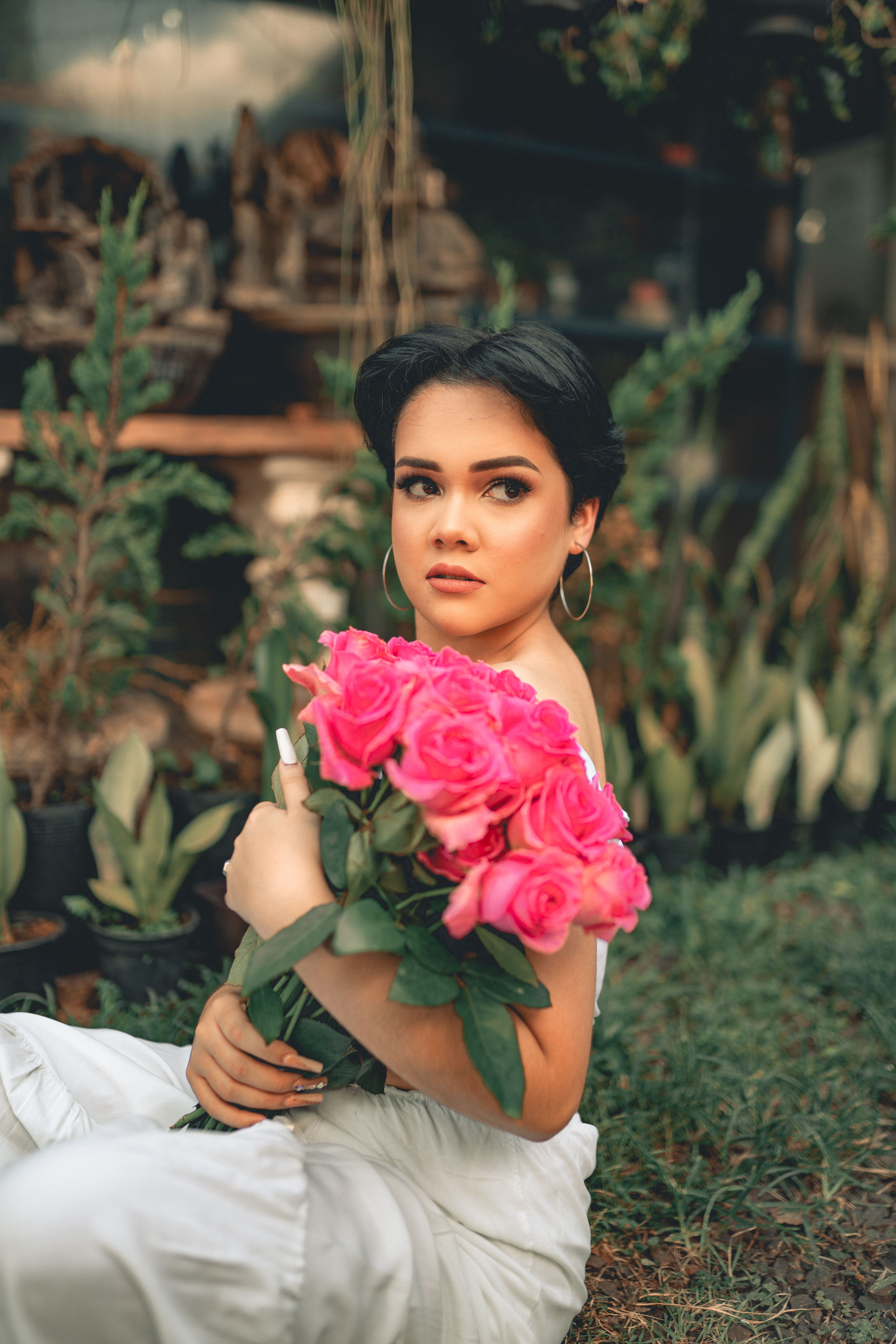 Woman Sitting and Posing with Roses · Free Stock Photo
