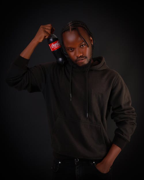 Model in Black Hoodie with Bottle of Coca-Cola