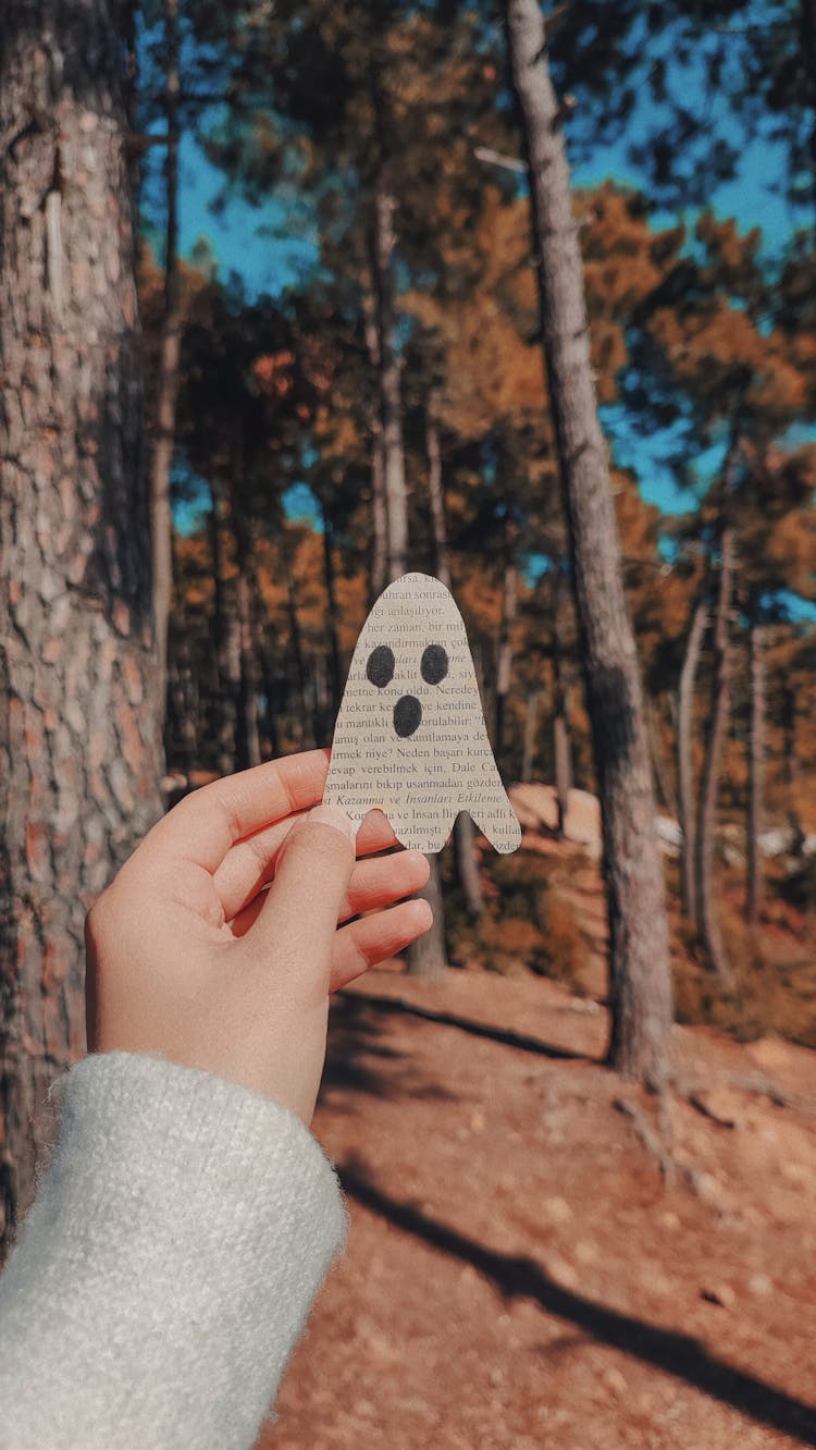 Hand Holding Ghost Paper In Forest