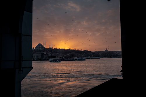 Free Dramatic sunset over Istanbul's skyline featuring mosques and the Bosphorus. Stock Photo