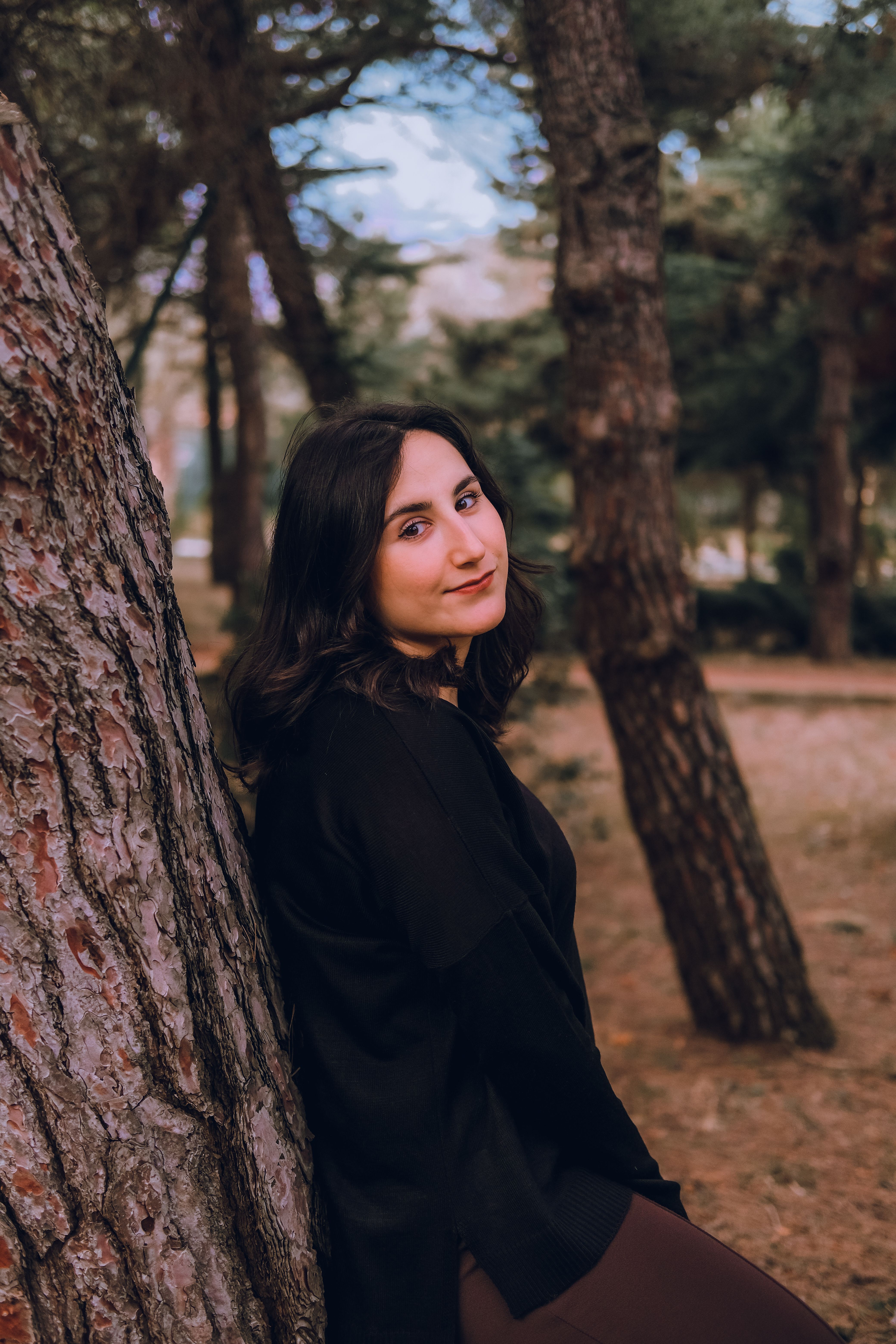 Smiling Woman Posing among Trees · Free Stock Photo