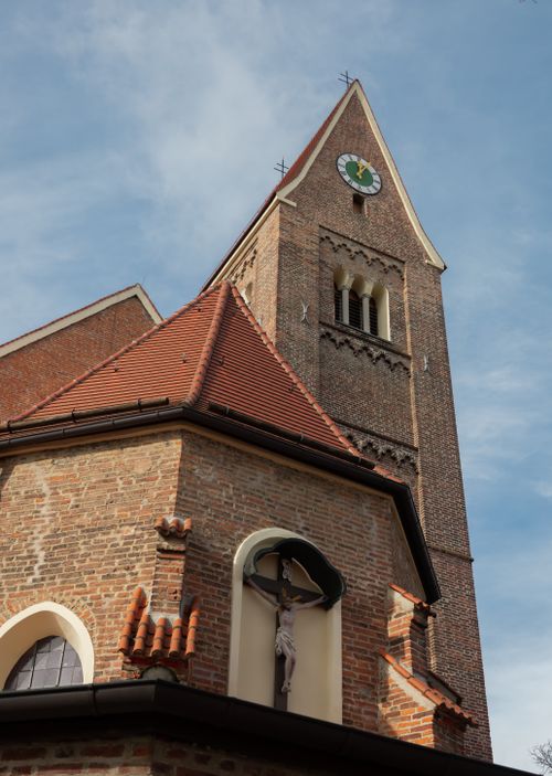 Free Medieval Gothic church tower with clock and crucifix under blue sky in Europe, showcasing architecture. Stock Photo