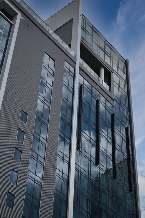 Free A striking view of a modern glass building reflecting the blue sky in Atlanta. Stock Photo