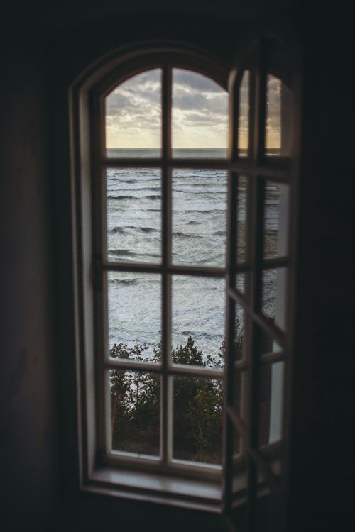 Free A tranquil scene of the ocean waves seen from a window in Užavas pagasts, Latvia. Stock Photo
