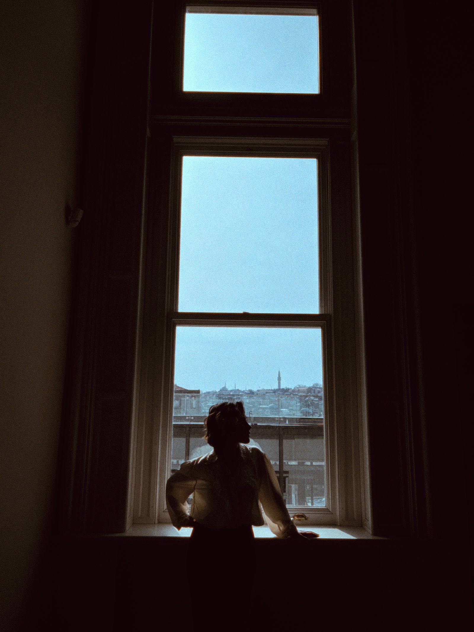 Person Standing by Sunlit Windows · Free Stock Photo