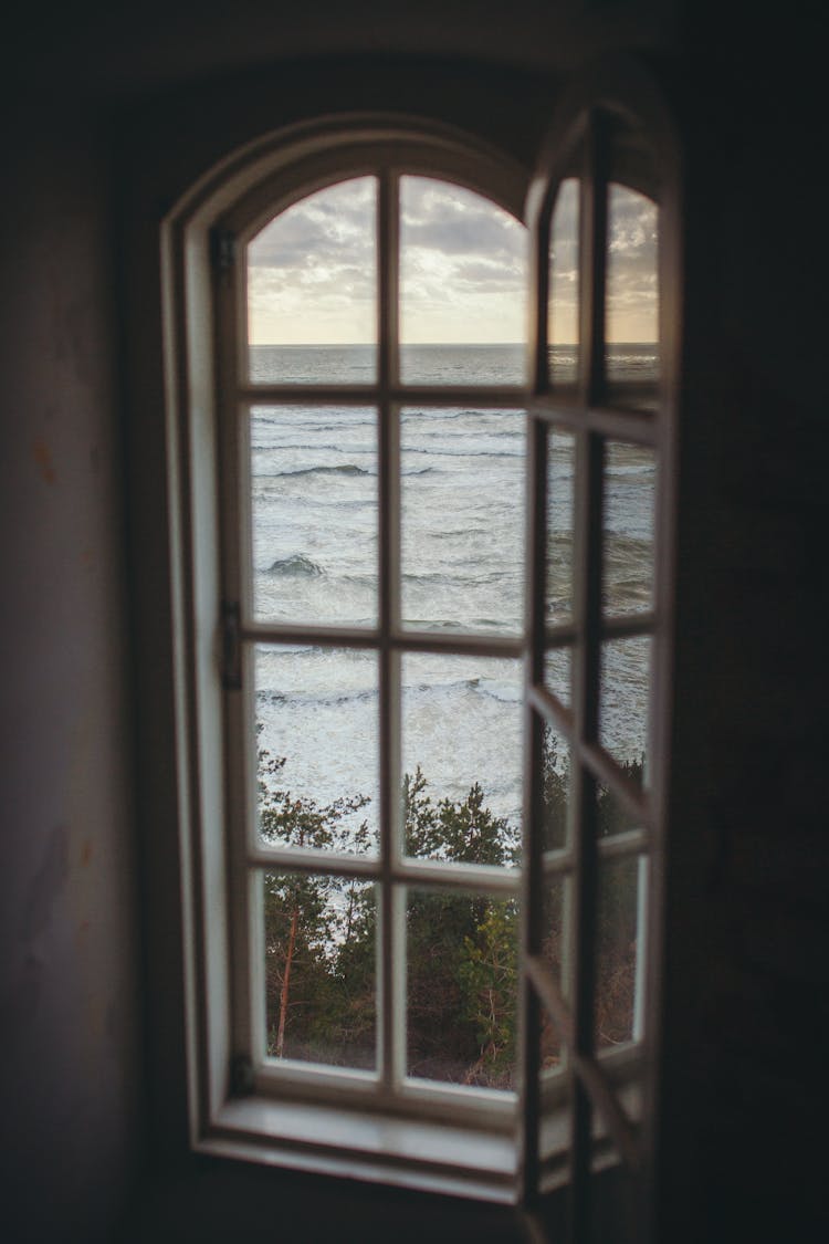 Photo Of A Window Overlooking The Ocean