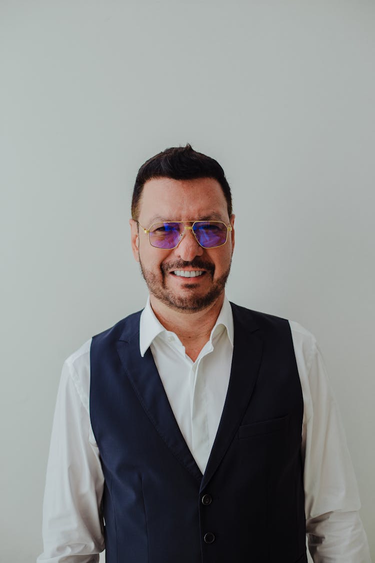 Portrait Of A Smiling Man In A Navy Blue Waistcoat