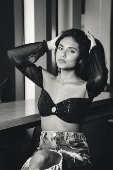 Elegant black and white fashion portrait of a woman in stylish attire