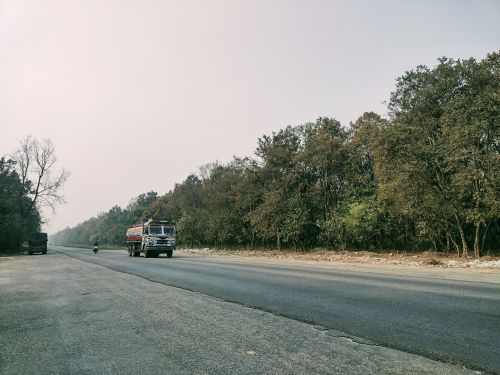 Free Wide view of a truck on a forest road in Amlekhganj, Nepal, showcasing nature and transport. Stock Photo