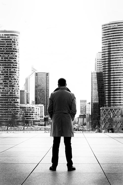 Monochrome Photo of Man Wearing Trench Coat