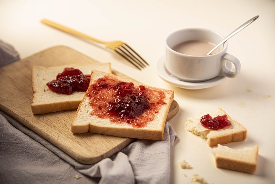 Best Bread Maker Machines 2026: Zojirushi vs Cuisinart vs Homemade bread with butter and jam on a breakfast table