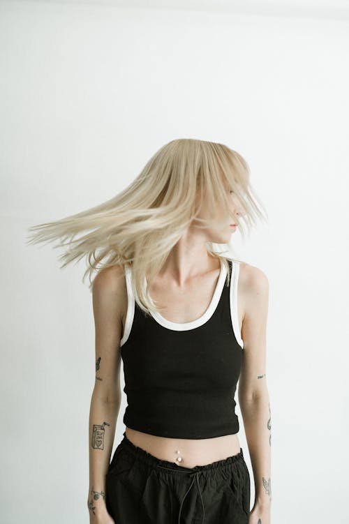 Young Woman with Tattoos Posing in Studio 