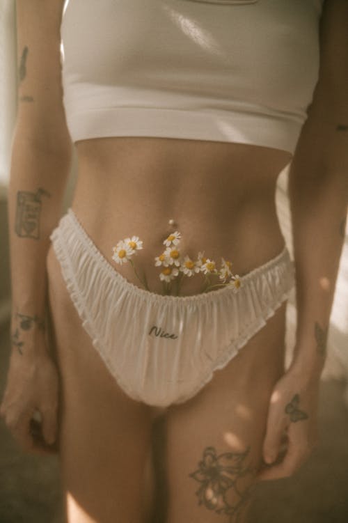 Woman with Tattoos and Flowers Sticking out from Her Underwear