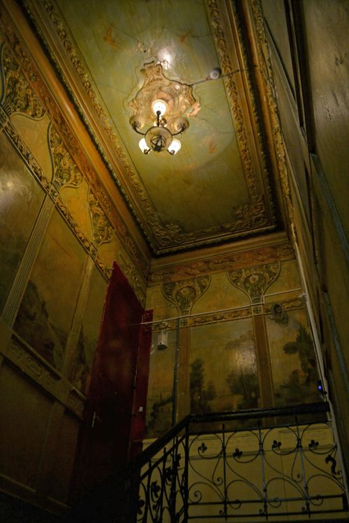 Free Elegant vintage staircase interior featuring ornate ceilings and detailed wall art. Stock Photo