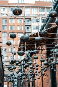 Captivating view of hanging lanterns in an urban alley with modern architecture.