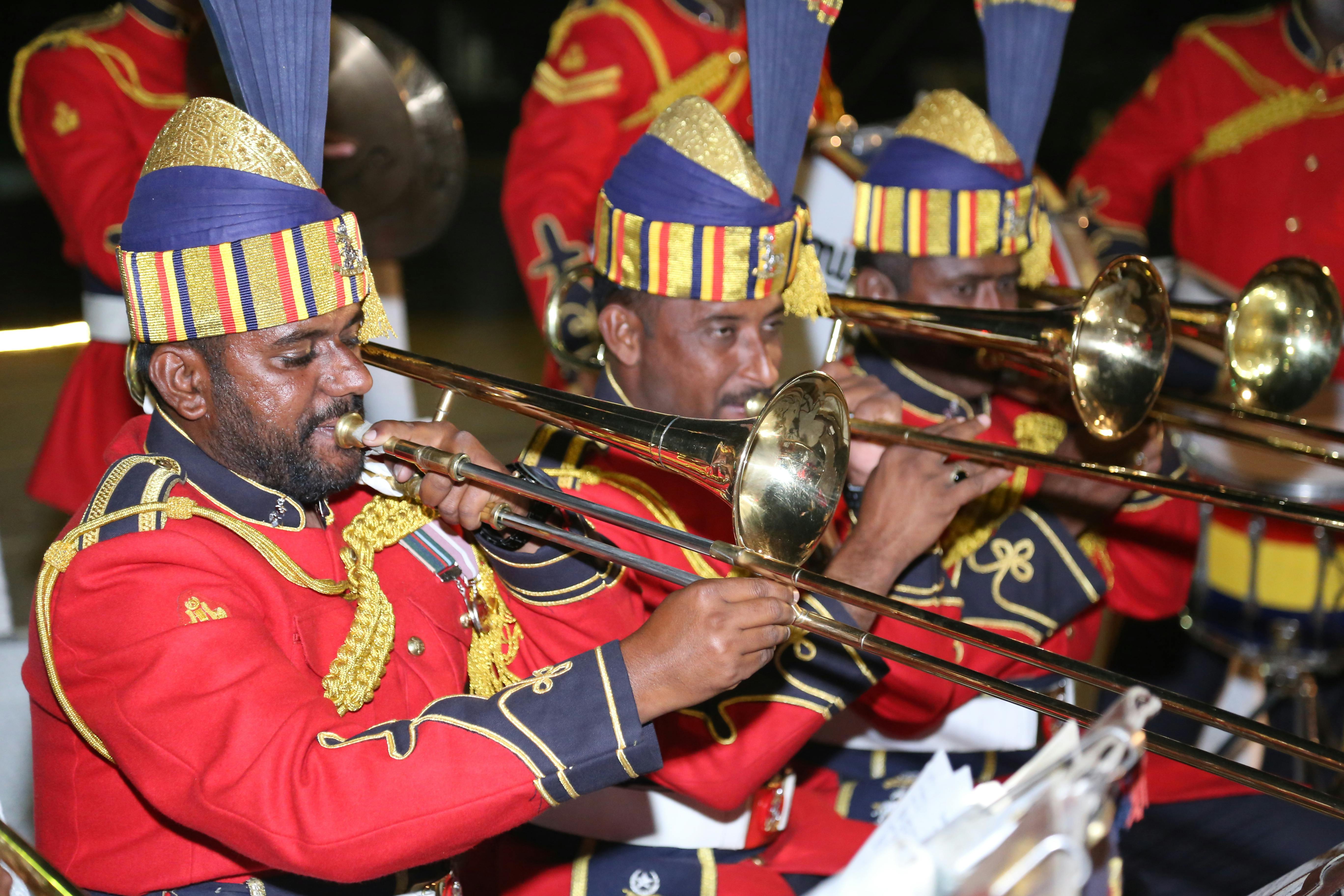 A vibrant scene of a traditional brass band performing in colorful uniforms with trombones.