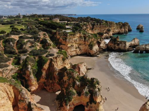 Free Aerial view of the rugged coastline and sandy beach in Alvor, Portugal. Stock Photo