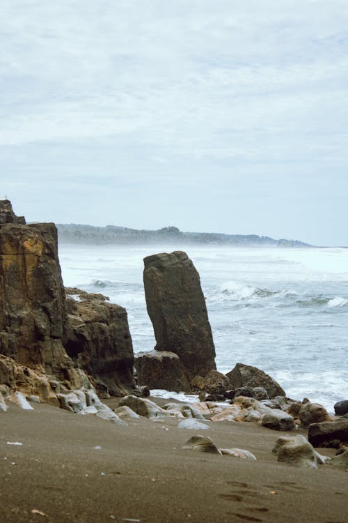 View of Rock Formations on a Beach and Rough Sea 