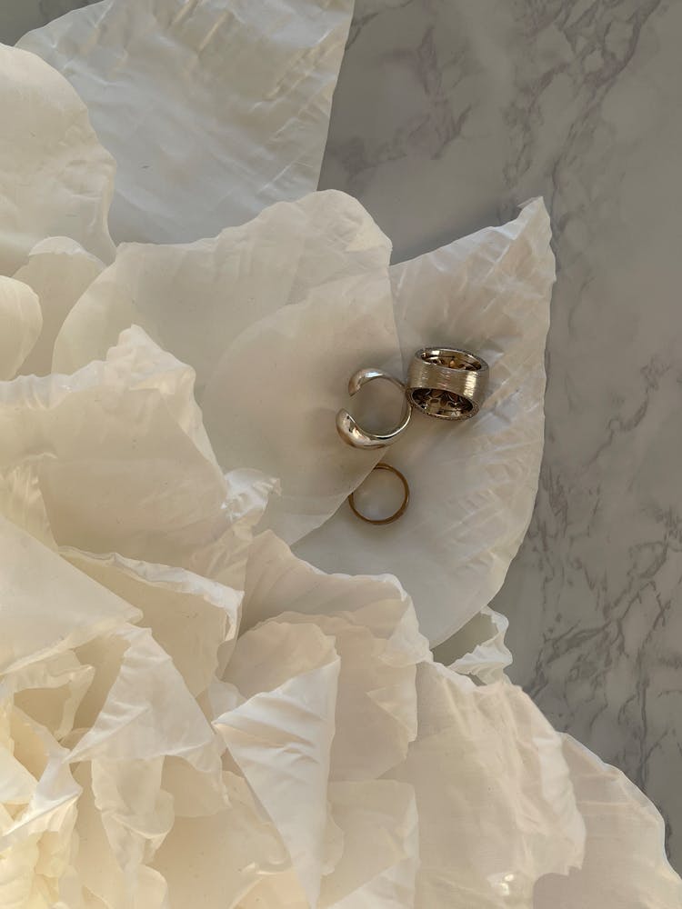 Rings And Sheet Of Paper On Marble Table