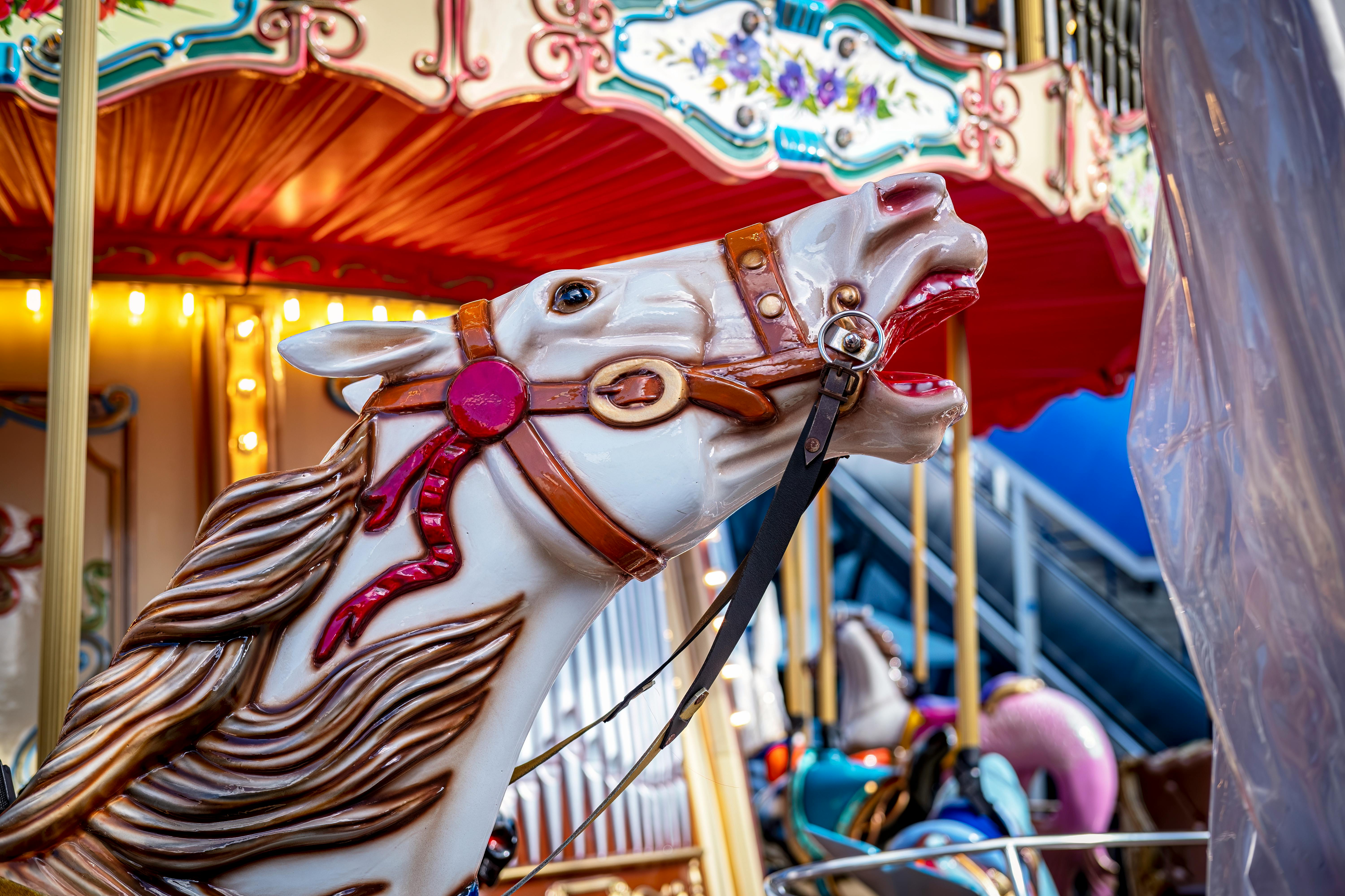 Vibrant carousel horse sculpture at a festival, capturing carnival excitement.