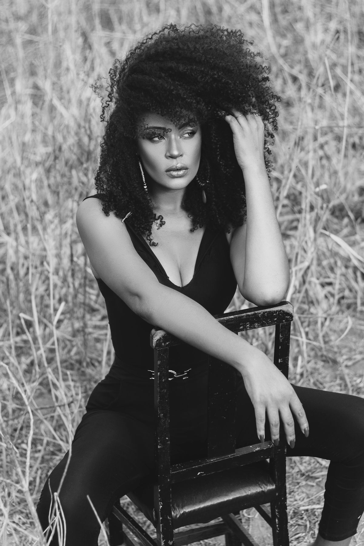 Woman in Black Blouse and Pants Sitting Backwards on a Chair · Free ...