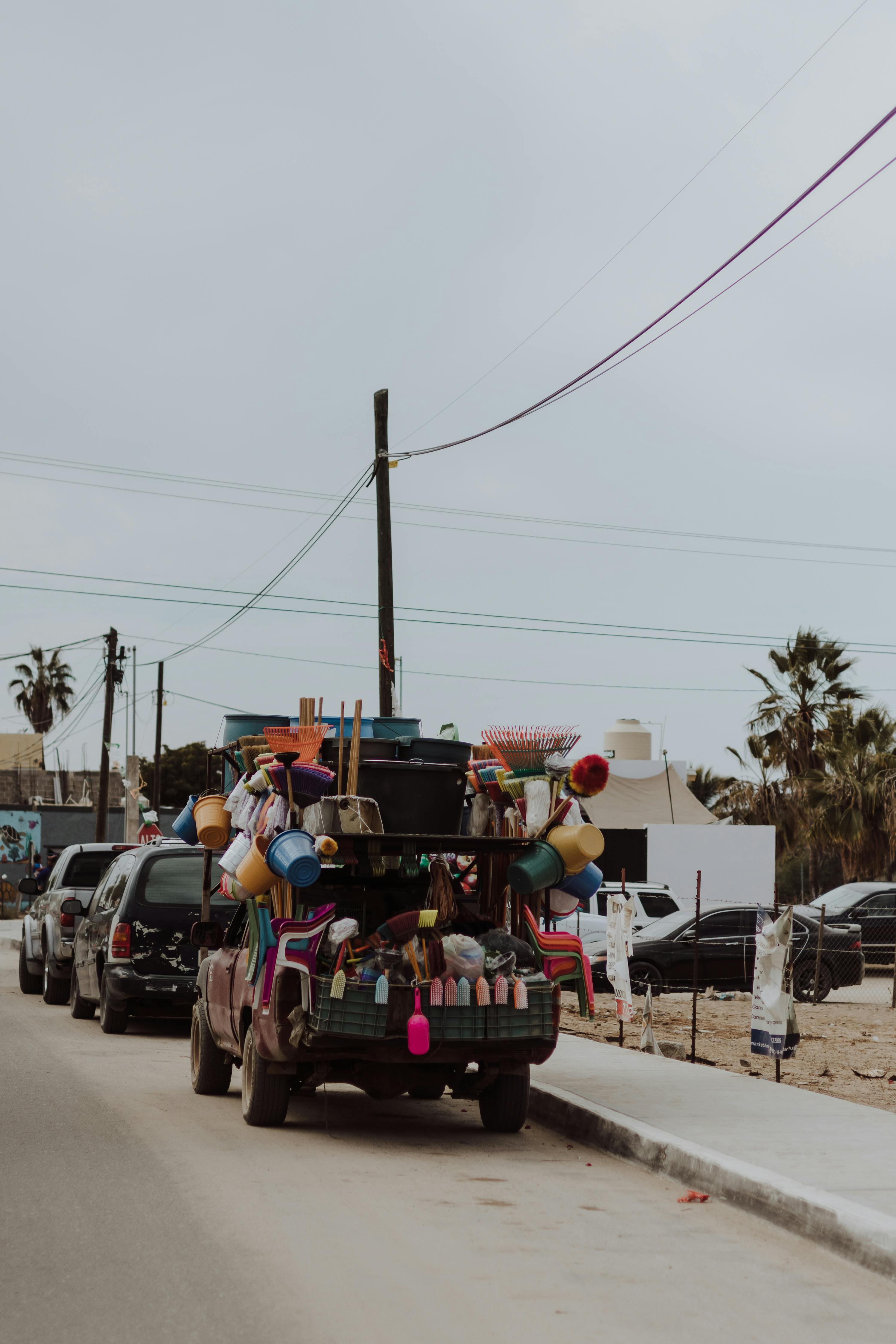 A vibrant vendor truck on a street in San Juan del Rancho, Mexico, selling household goods.