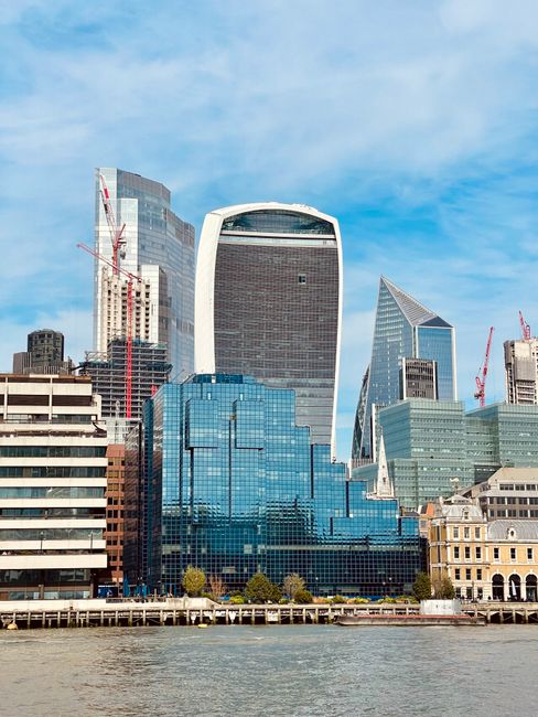 A stunning view of London's modern skyline featuring distinctive skyscrapers near the Thames River.