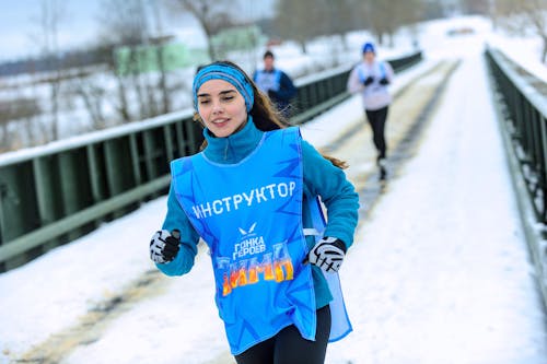 Girl Running Marathon in Winter