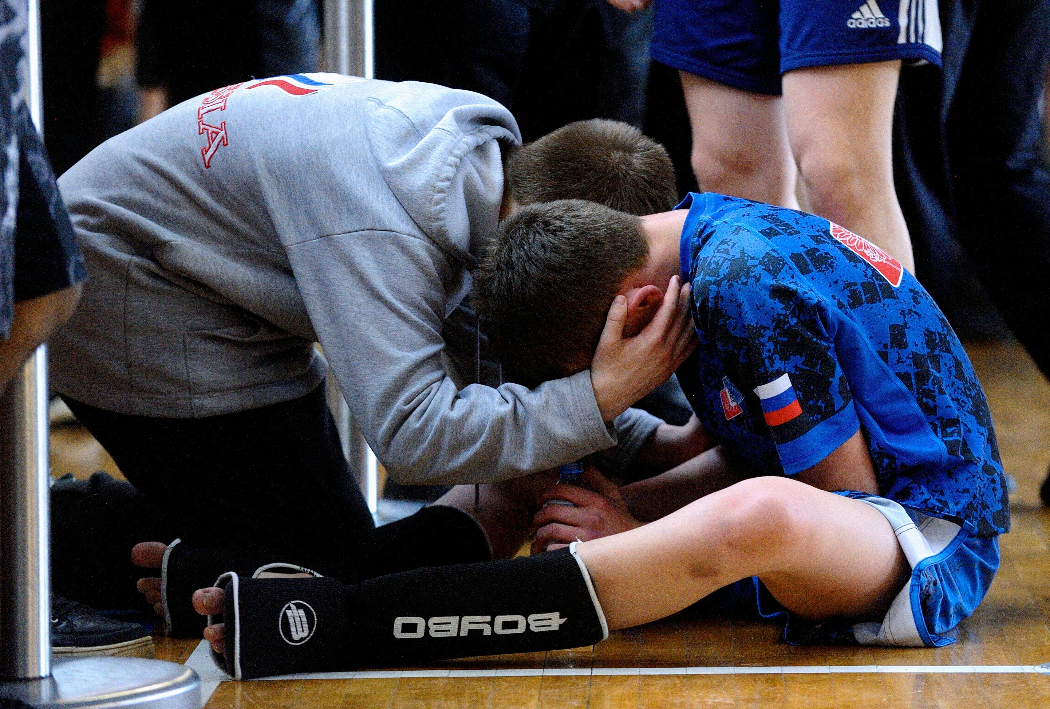 coach talking to a boy during the match