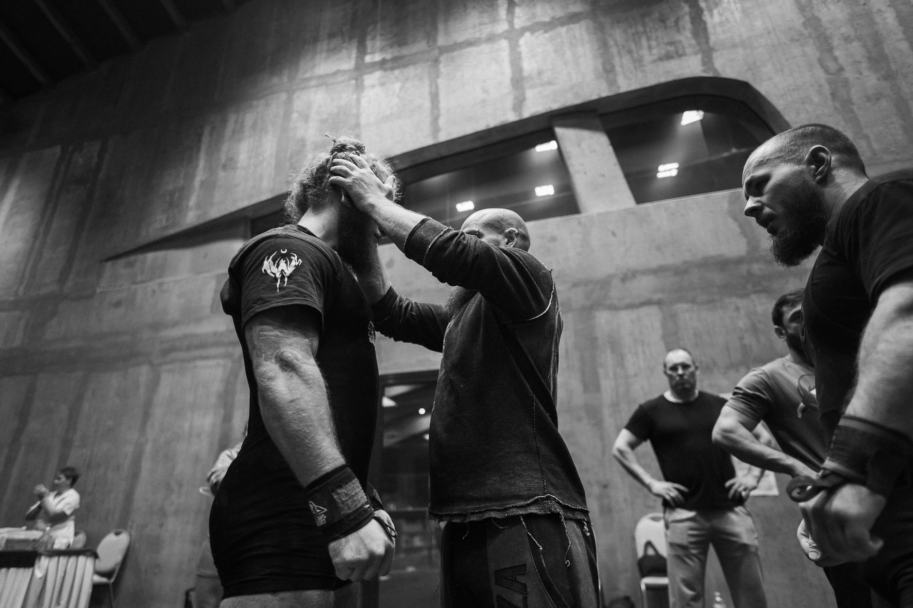 Athletes preparing for a sports event, showcasing focus and intensity in a black and white setting.