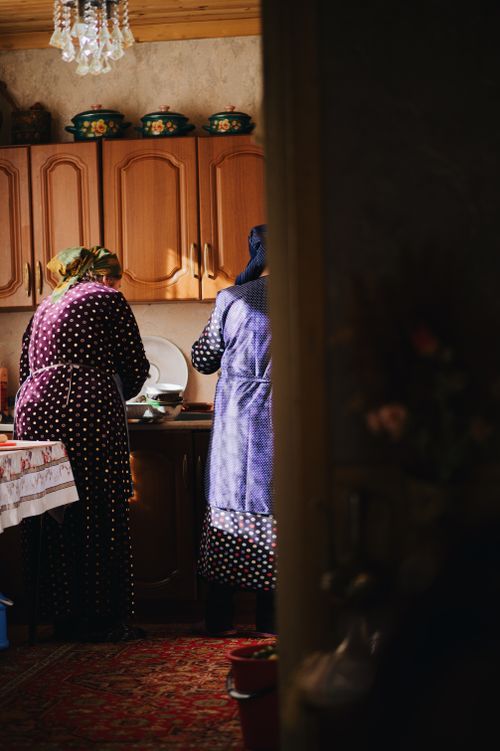 Free Two women in a rural kitchen preparing meals, showcasing traditional domestic life. Stock Photo