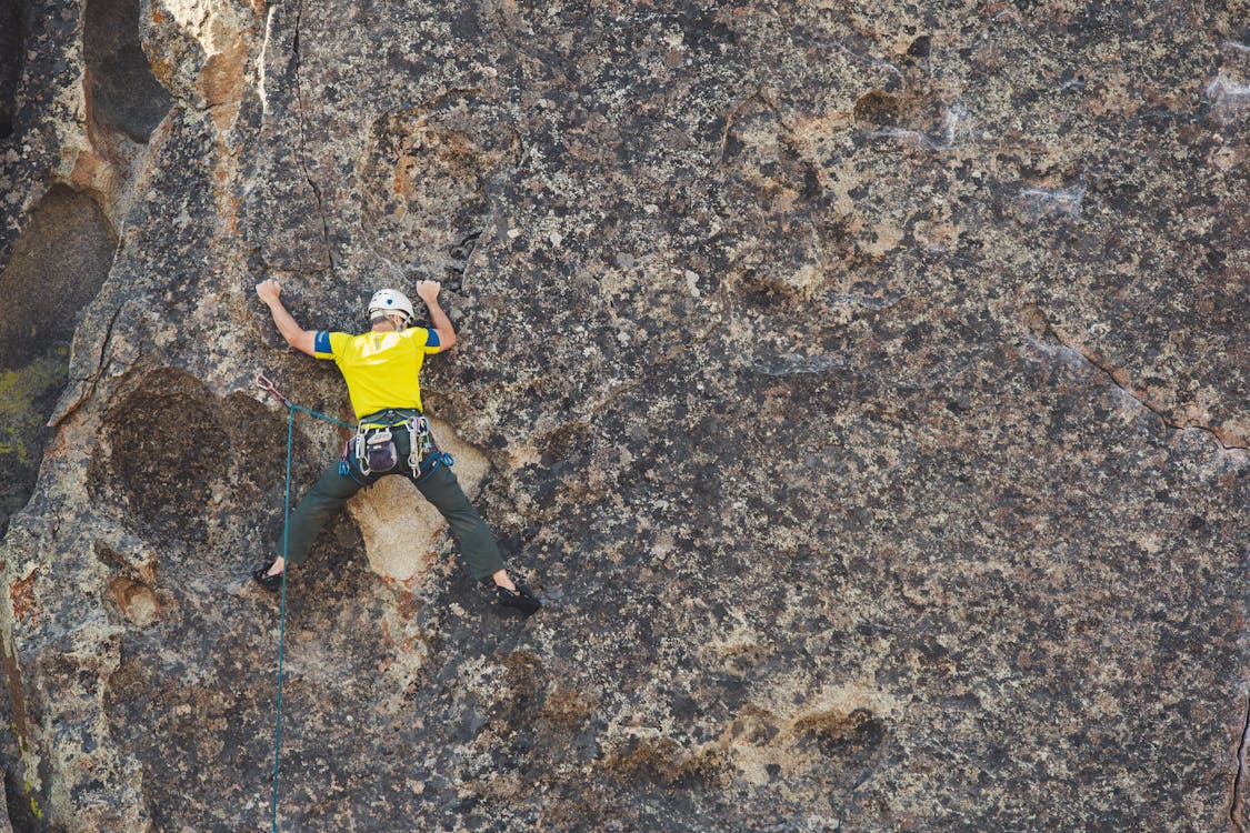 Free Man Doing Outdoor Rock Climbing Stock Photo