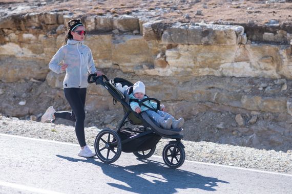 A jogging stroller on a bright outdoor path