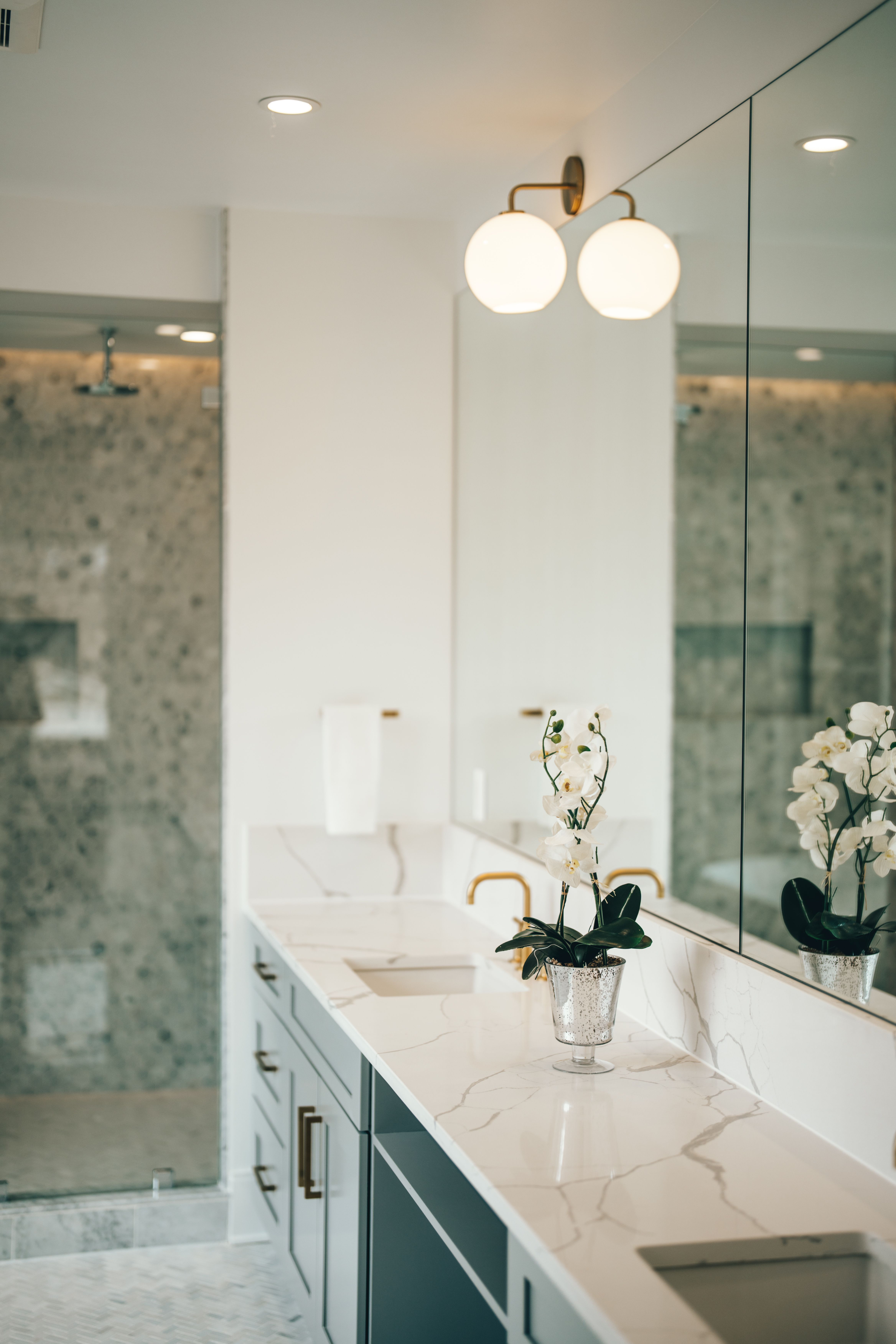 Bathroom interior with marble countertops and gold fixtures