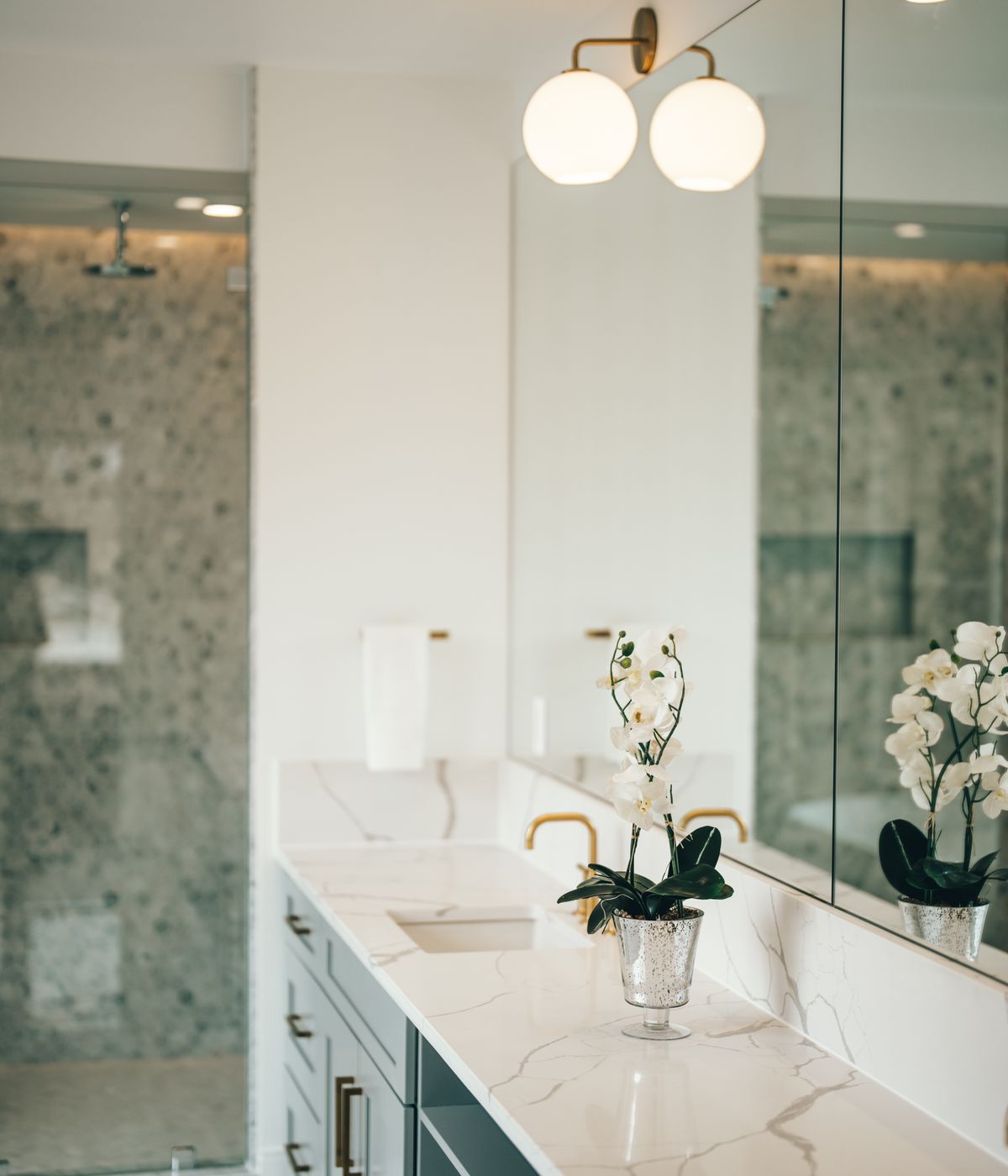 Bathroom interior with marble countertops and gold fixtures