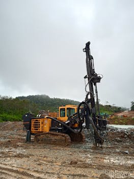 Vertical shot of construction equipment in a muddy site at Simpenan, Indonesia.